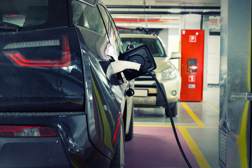 Electric,Car,At,Charging,Station,Indoor,Underground,Parking,In,Basement